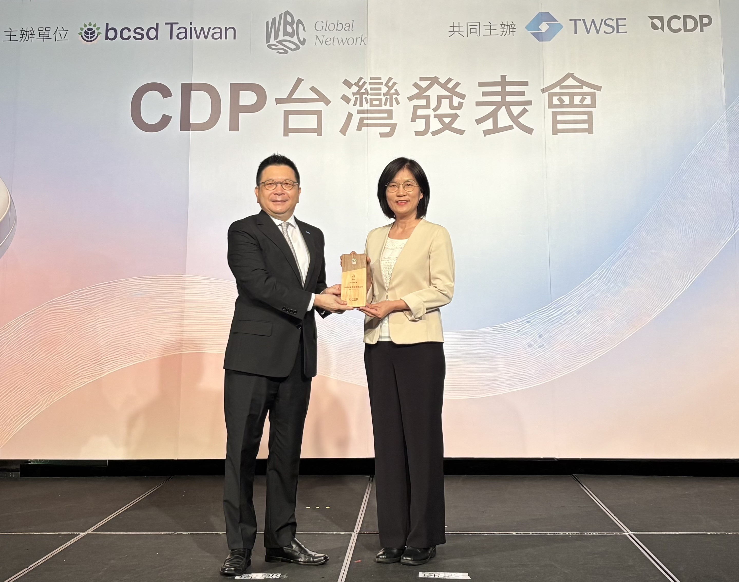 友達永續成果再獲國際評比肯定，獲頒CDP氣候與水資源雙項領導力評級。今由臺灣證券交易所董事長林修銘（左）頒獎，友達光電永續長古秀華（右）代表受獎